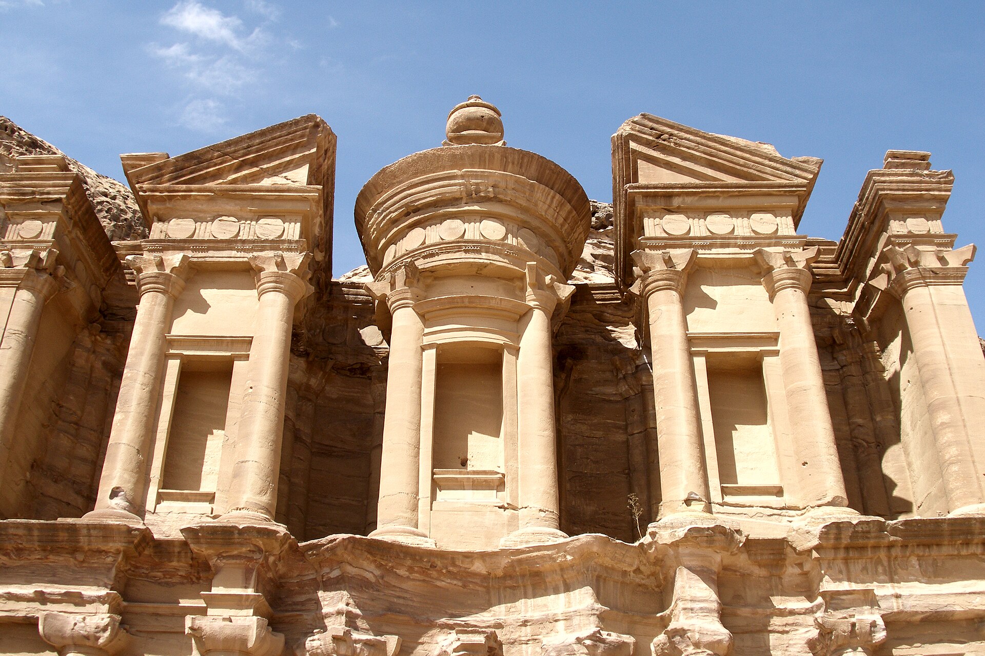 The Monastery, Ad Deir, at Petra: a huge classical facade carved directly into the rock face, with the surrounding hills visible beyond.