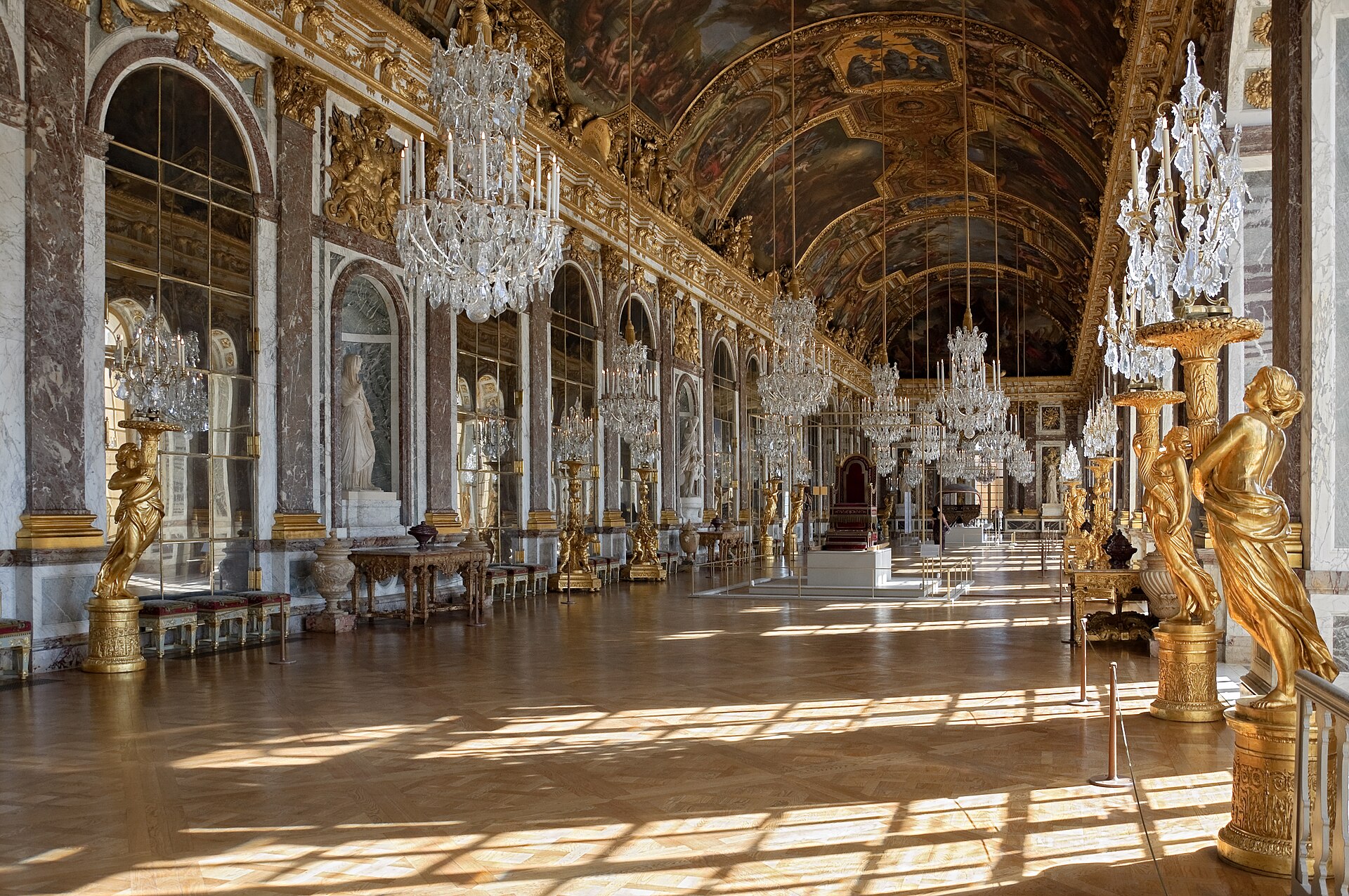 The Hall of Mirrors at the Palace of Versailles, a long barrel-vaulted gallery lined with arched mirrors and chandeliers.