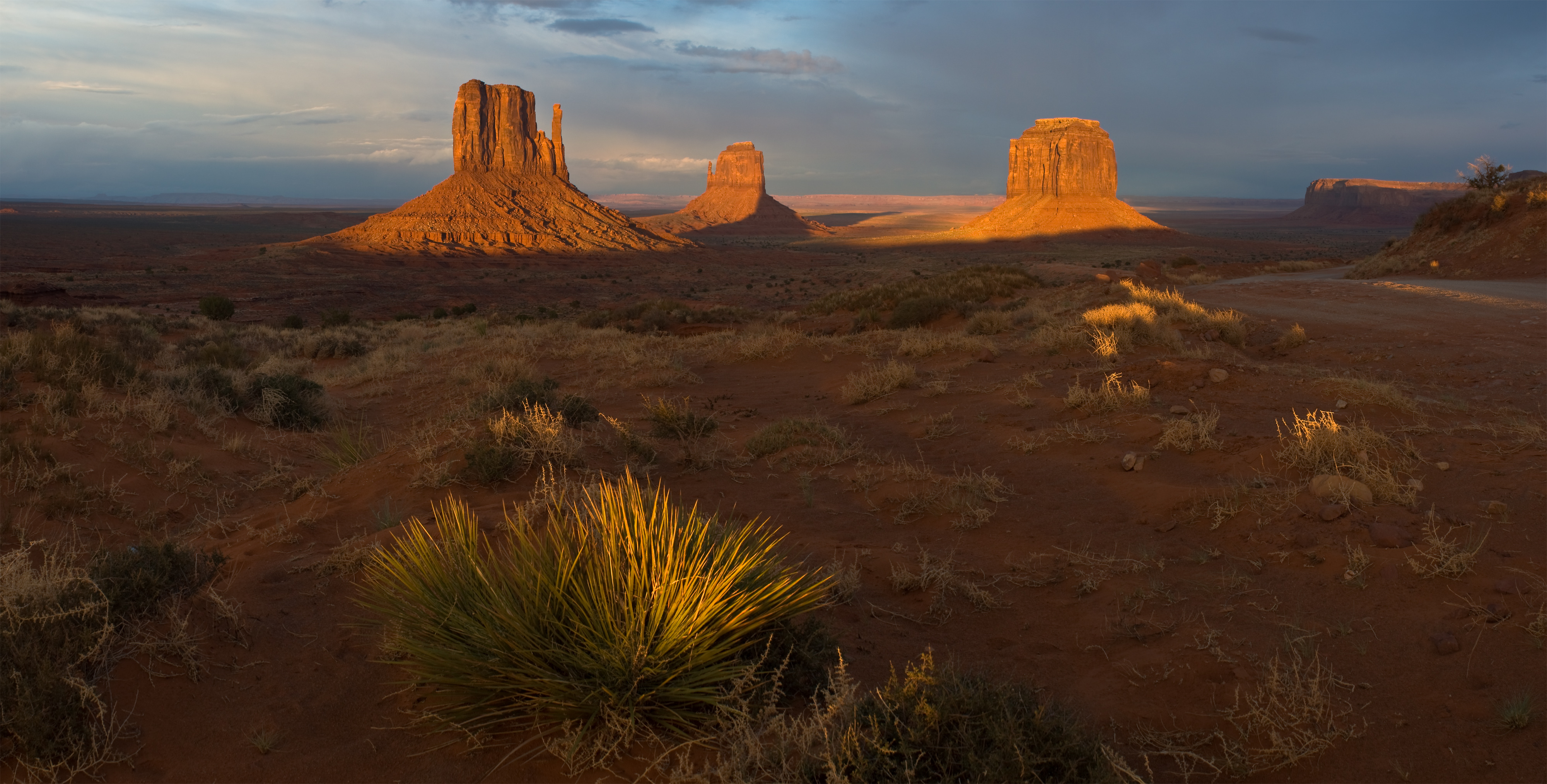 The Mitten buttes of Monument Valley at sunset, on Navajo Nation land straddling the Utah-Arizona border.