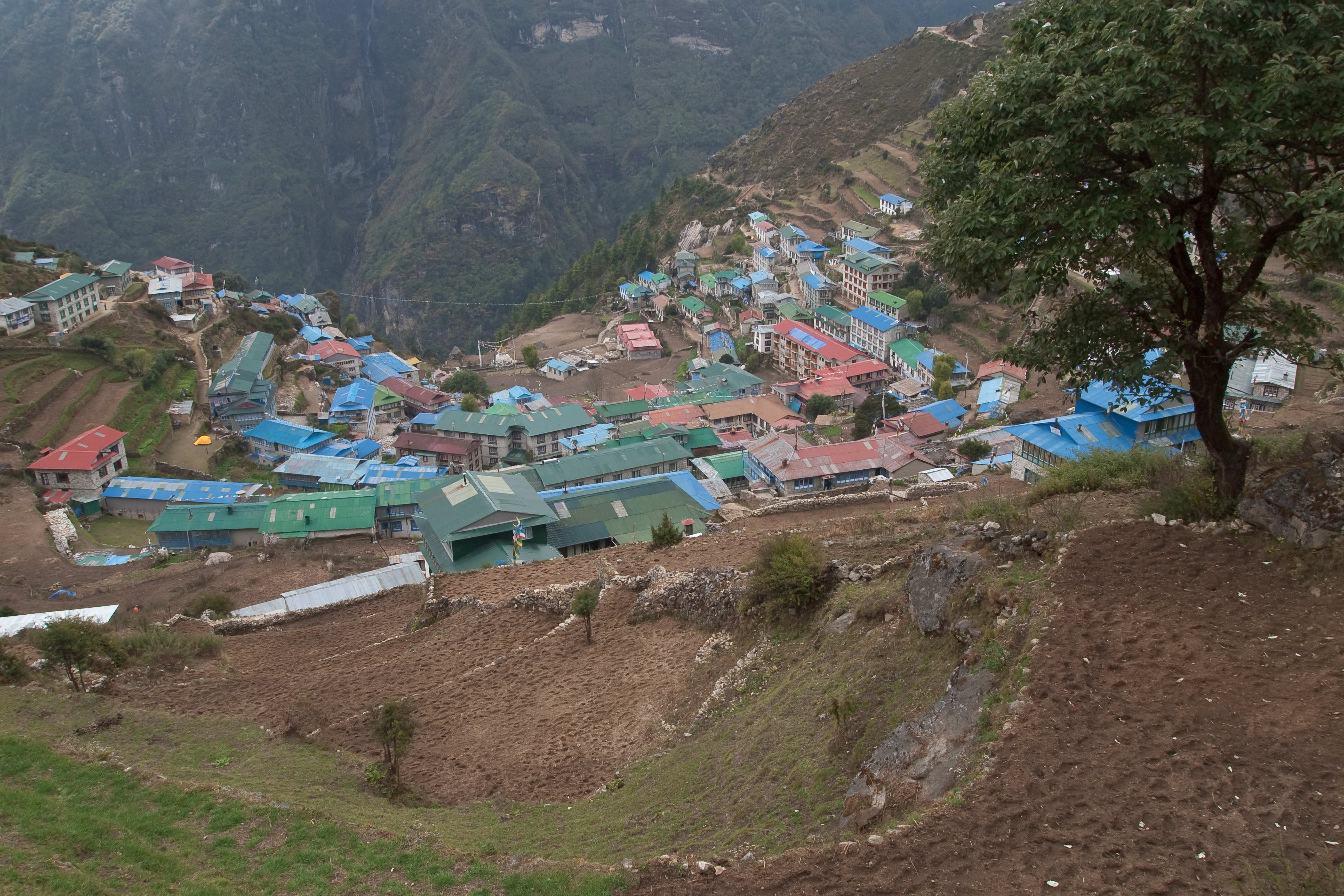 Namche Bazaar, the Sherpa trading town on the Everest Base Camp trail, with terraced buildings set against the surrounding Himalayan peaks.