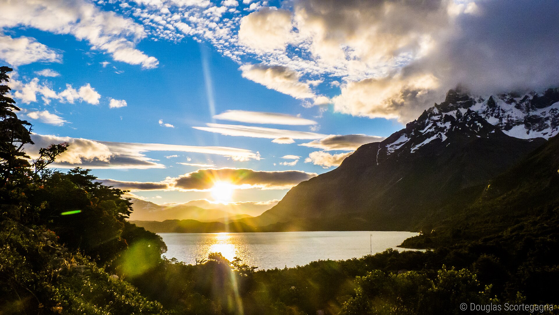 Golden evening light on the granite peaks of the Paine massif in Torres del Paine National Park, Chile, above open steppe grassland.
