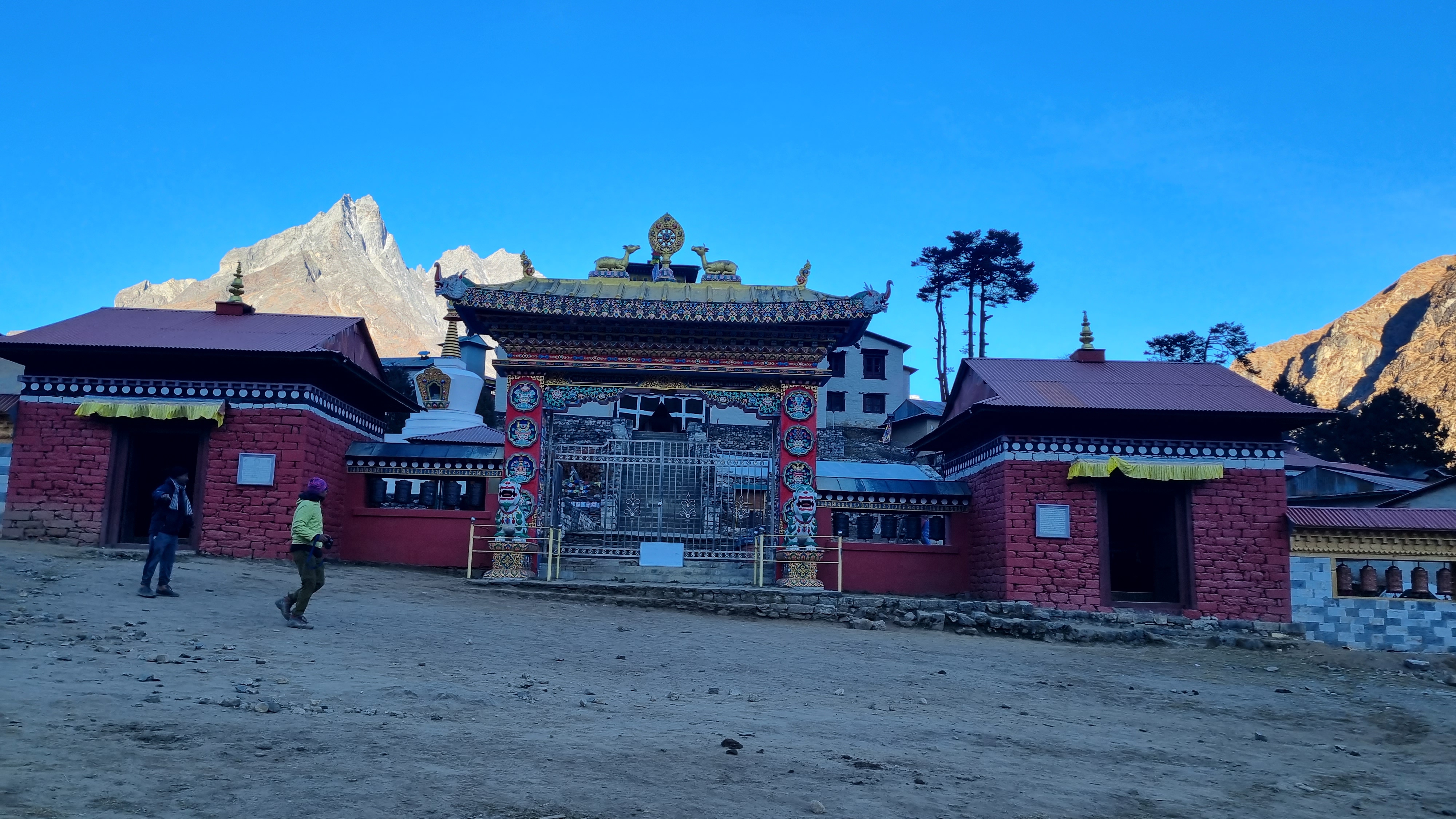 Tengboche Monastery on the Everest Base Camp trek route in Nepal, its red and white buildings set against snow-covered Himalayan peaks.